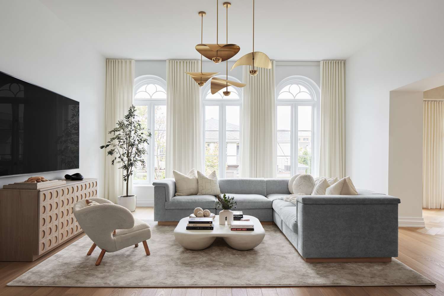 Salón rediseñado con luz natural y planos de proyecto sobre la mesa